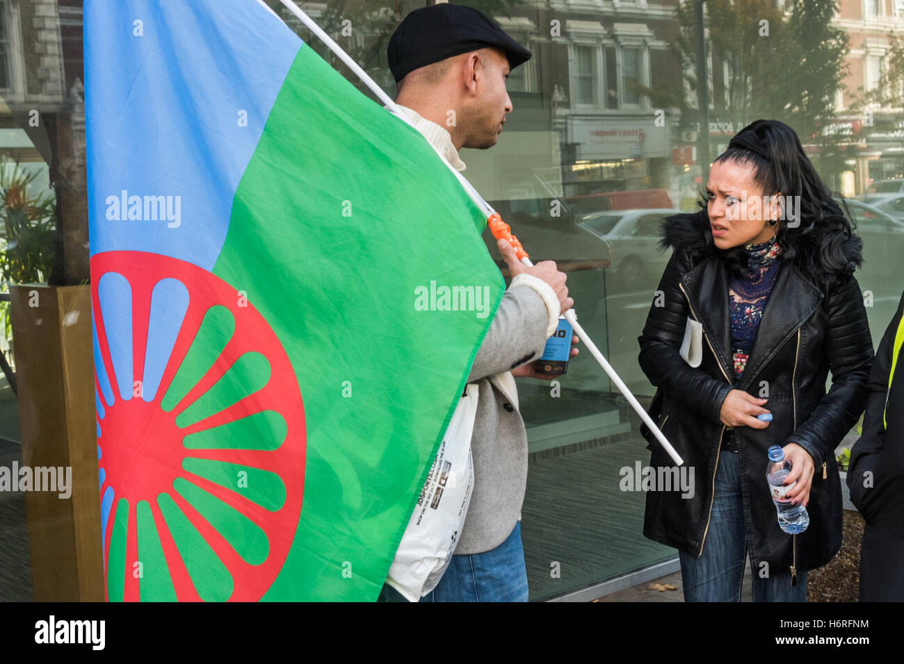 London, UK. Mon 31st October 2016. Roma living in the UK came with a Roma flag to protest at the Czech embassy in London after a young Romani man was attacked and killed by neo-Nazi skinheads as he went to buy cigarettes at a pizzeria in Žatec. The murdered man until a year ago was living in the UK and was a second cousin of Ladislav Balaz, Chair of the Roma Labour Group and Europe Roma Network, who came to hand a letter calling for the murder to be properly investigated to a representative from the Embassy. Credit:  Peter Marshall/Alamy Live News Stock Photo