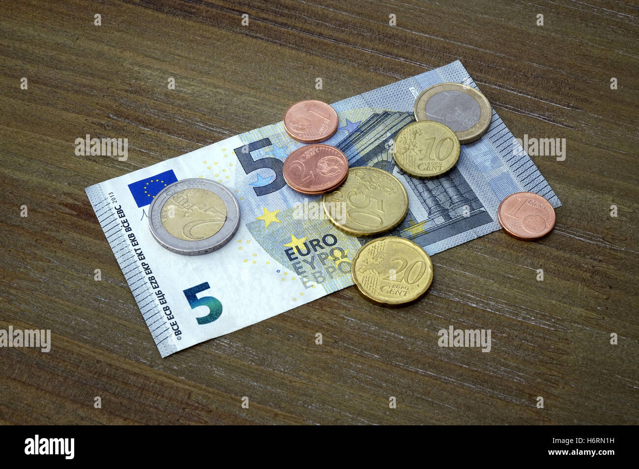 Berlin, Germany. 24th July, 2016. ILLUSTRATION - 8.84 Euros lying on a table. Taken on 24.07.2016. From 2017 this amount will come into effect as the legal minimum hourly wage. Photo: S, Steinach. - NO WIRELESS SERVICE - | usage worldwide/dpa/Alamy Live News Stock Photo