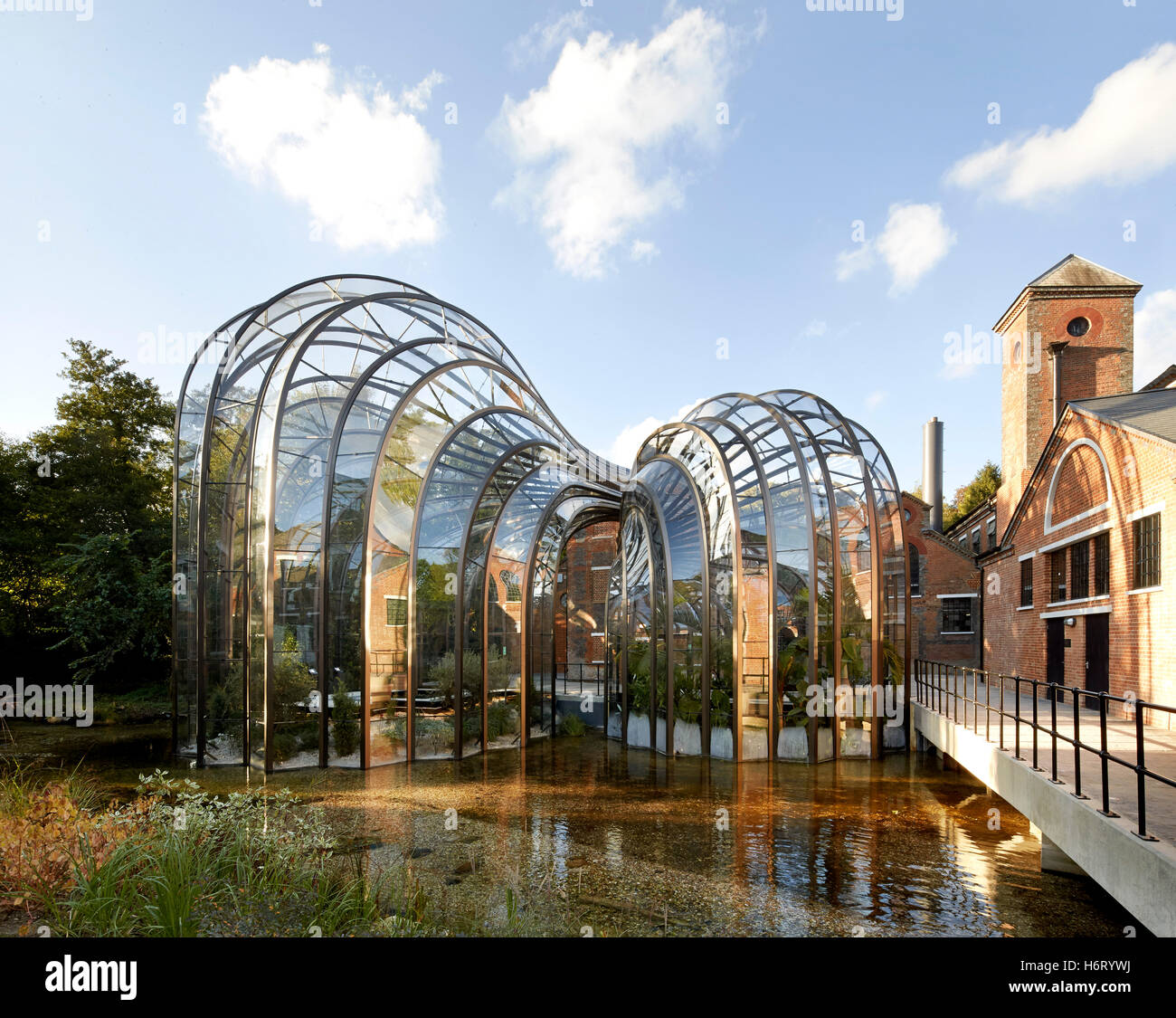 Historic mill site with curving greenhouse additions. Bombay Sapphire ...