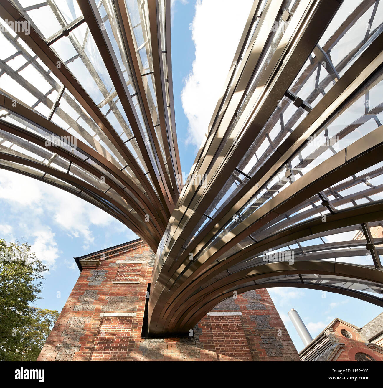 Glass and  metal piping connecting distillery room with greenhouses. Bombay Sapphire Distillery, Laverstoke, United Kingdom. Architect: Heatherwick, 2014. Stock Photo