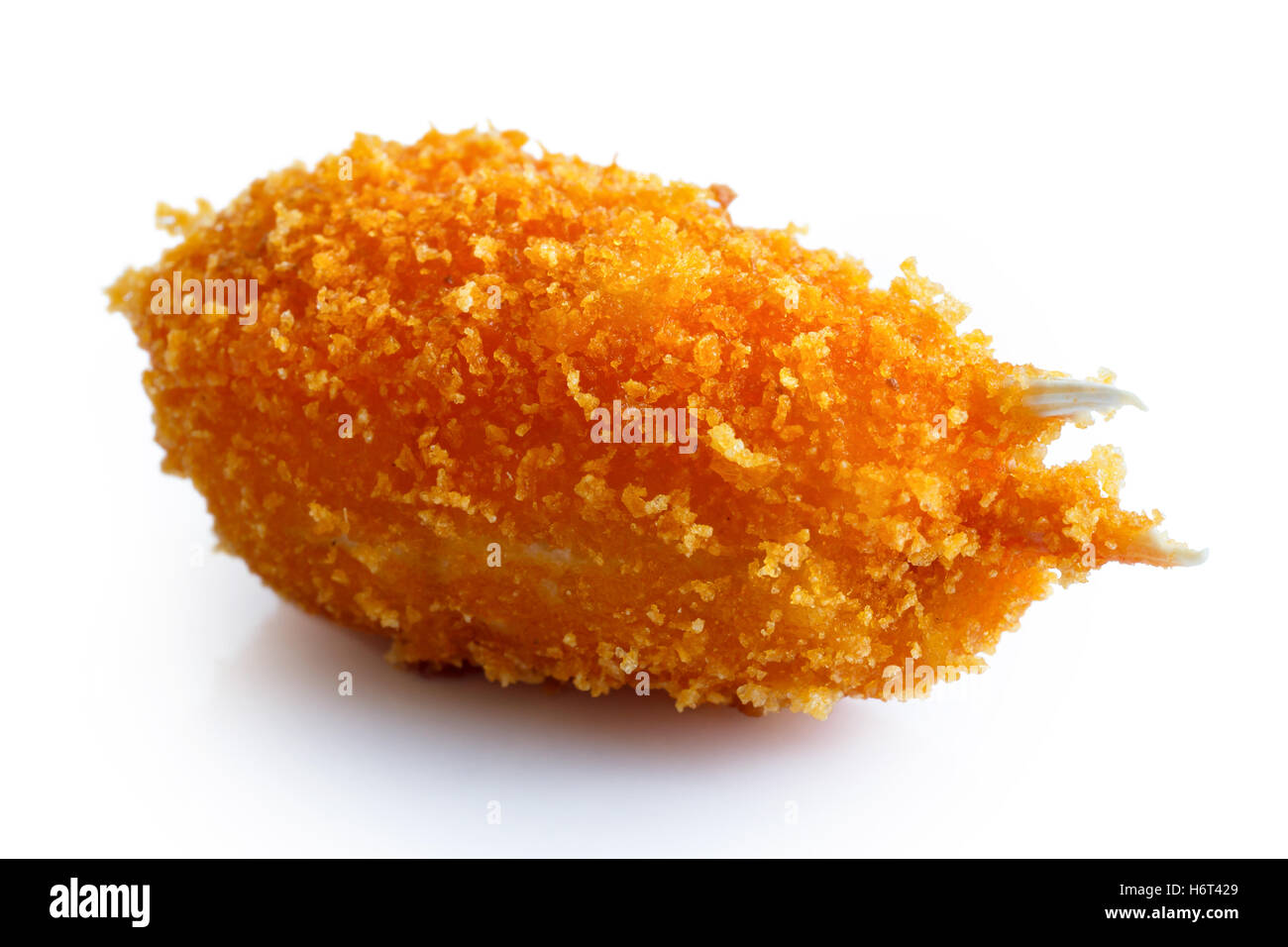 Detail of a fried breaded surimi crab claw isolated on white in perspective. Stock Photo