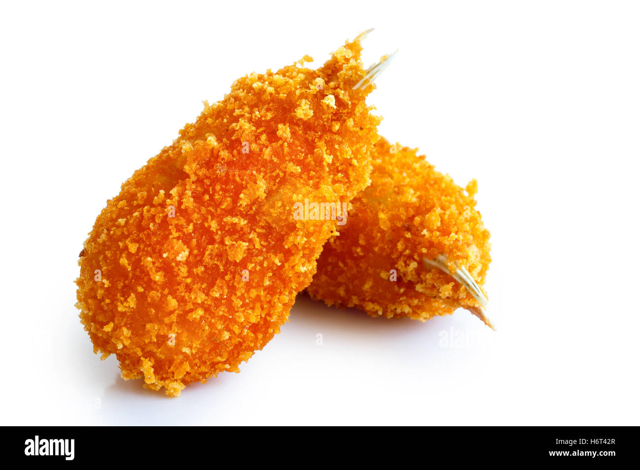 Two fried breaded surimi crab claws, in perspective, isolated on white. Stock Photo