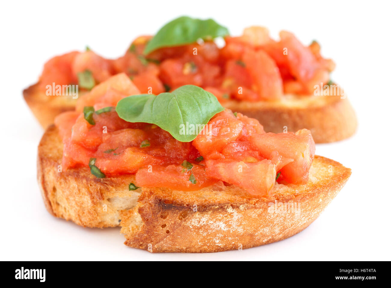Classic italian bruschetta with tomato and basil on grilled bread. Stock Photo