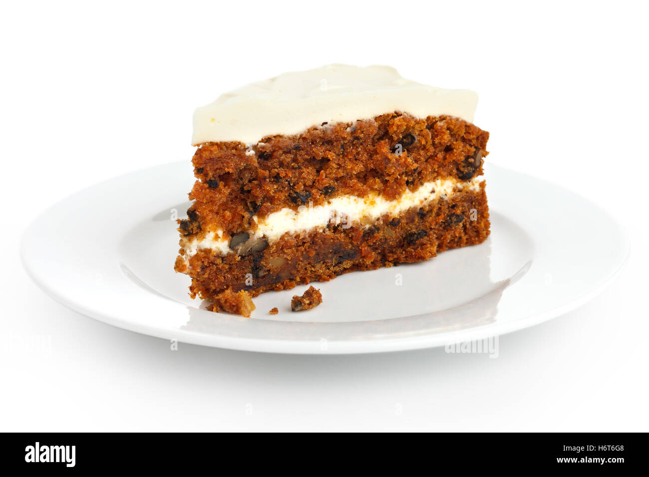Slice of carrot cake with rich frosting. On plate. Stock Photo