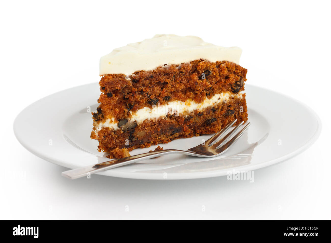 Slice of carrot cake with rich frosting. On plate. Stock Photo