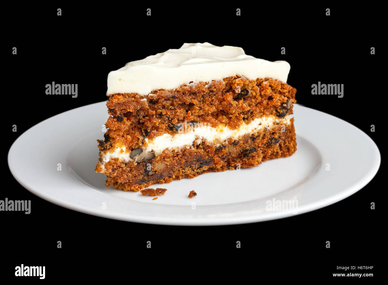 Slice of carrot cake with rich frosting. On plate. Stock Photo