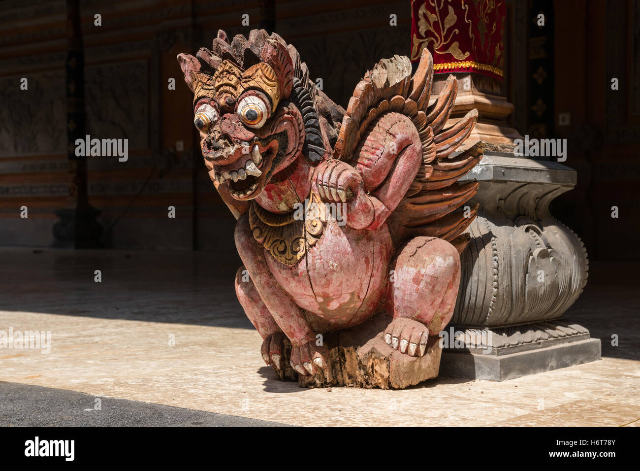 Old, painted, wooden statue at the hindu Puri Kantor temple, Ubud, Bali, Indonesia. Stock Photo