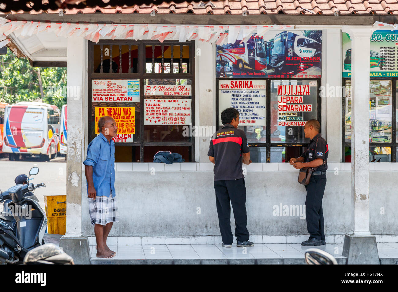 Unidentified Indonesian people at a ticket office at Ubung Bus Terminal, Bali, Indonesia. Stock Photo