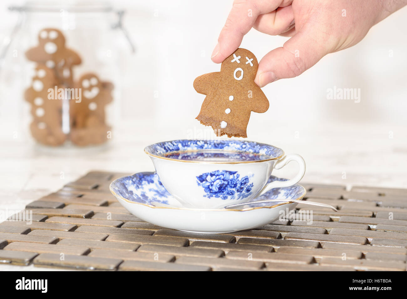 Funny gingerbread man with no legs after being dipped into hot tea Stock Photo