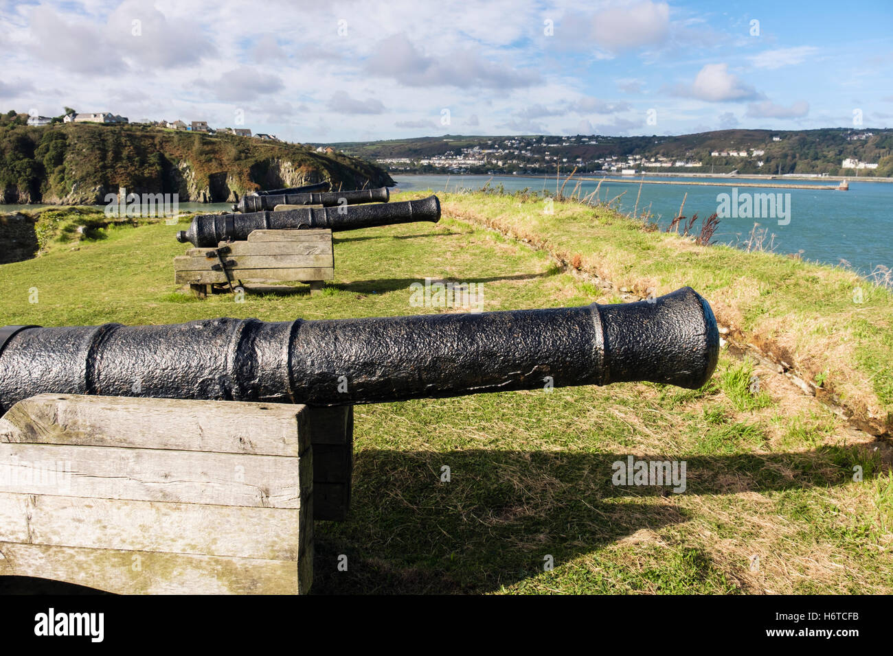 Old 9 pounder guns in 18th century fort ruins 1781 on a headland overlooking port. Fishguard, Pembrokeshire, Wales, UK Stock Photo