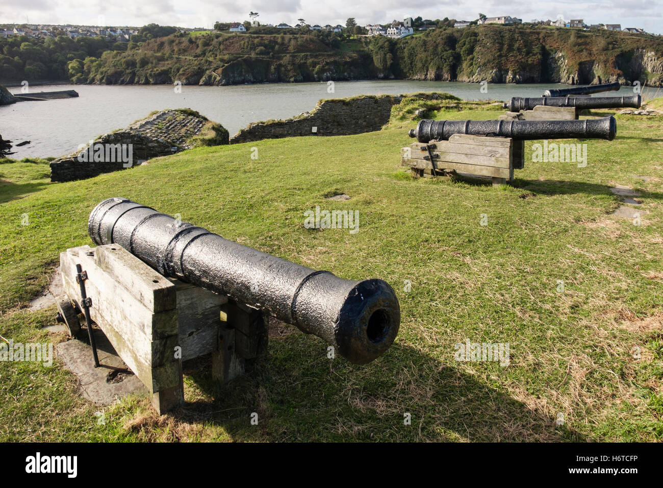 Old 9 pounder guns in 18th century fort ruins 1781 on a headland overlooking port. Fishguard, Pembrokeshire, Wales, UK Stock Photo
