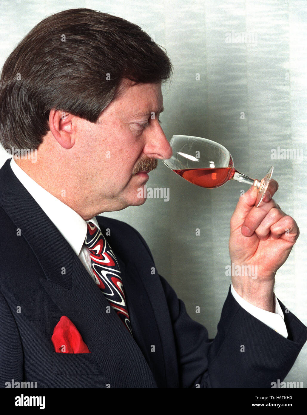A whisky blender 'nosing' a glass of Scottish malt whisky Stock Photo