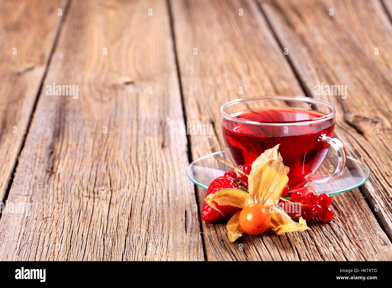 cup still life glass chalice tumbler tea drink drinking bibs closeup fruit saucer beverage strawberry nobody rustical rustic Stock Photo