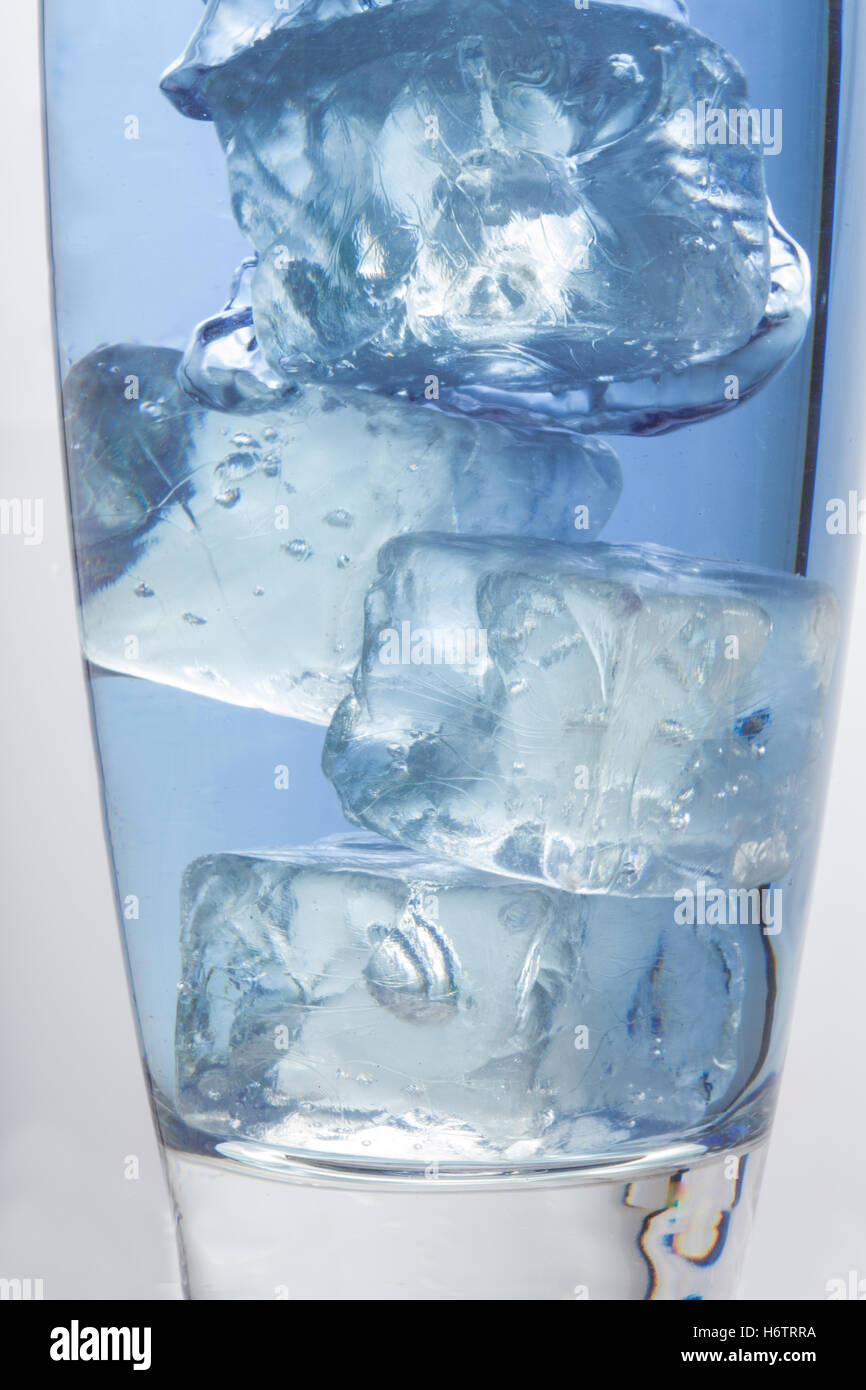 Close up on big ice cubes into glass of water Stock Photo - Alamy
