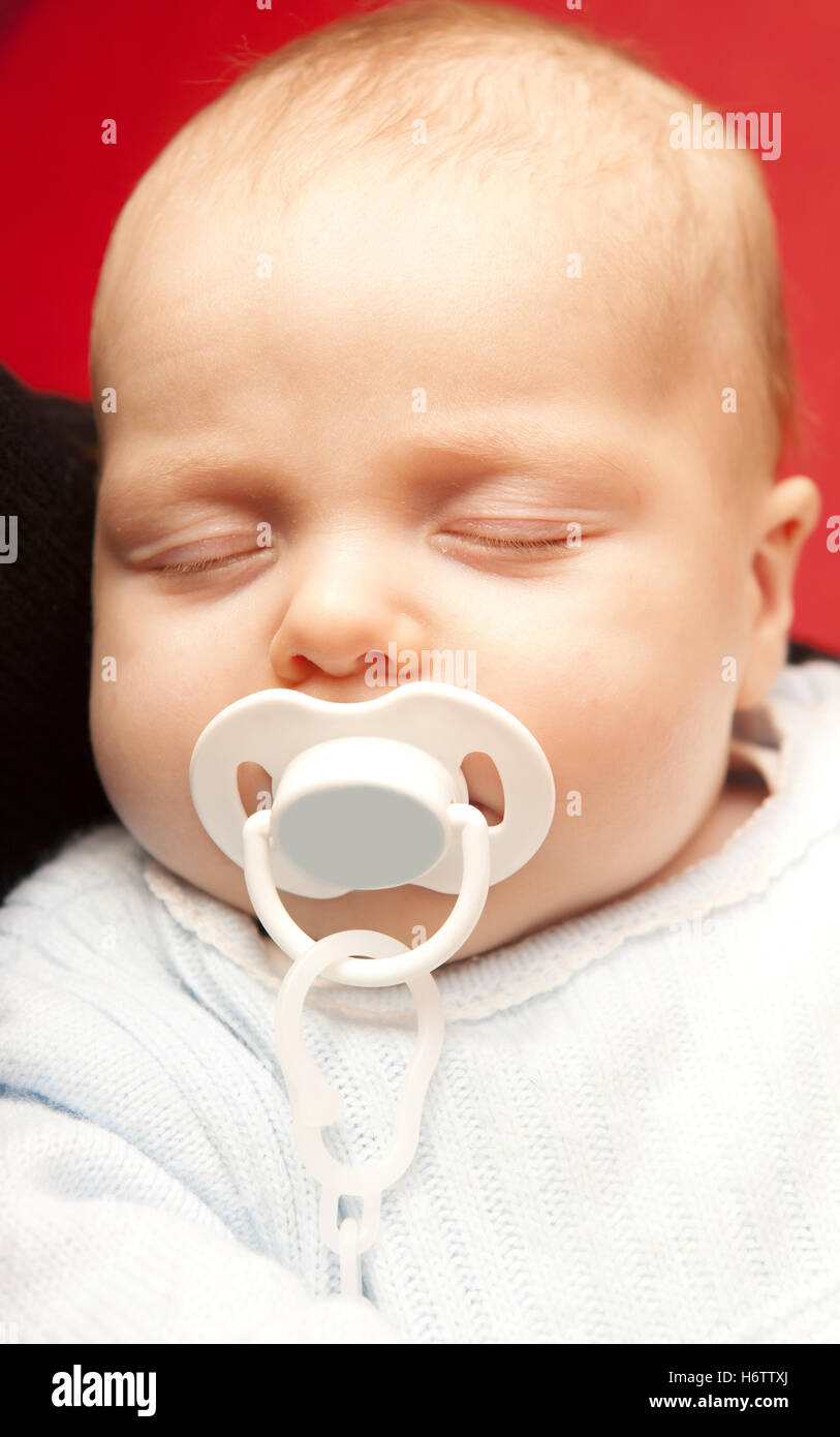 dream baby sleep sleeping innocence facilitate ease resting relax recover relaxing recovering locking bedtime adorable pacifier Stock Photo