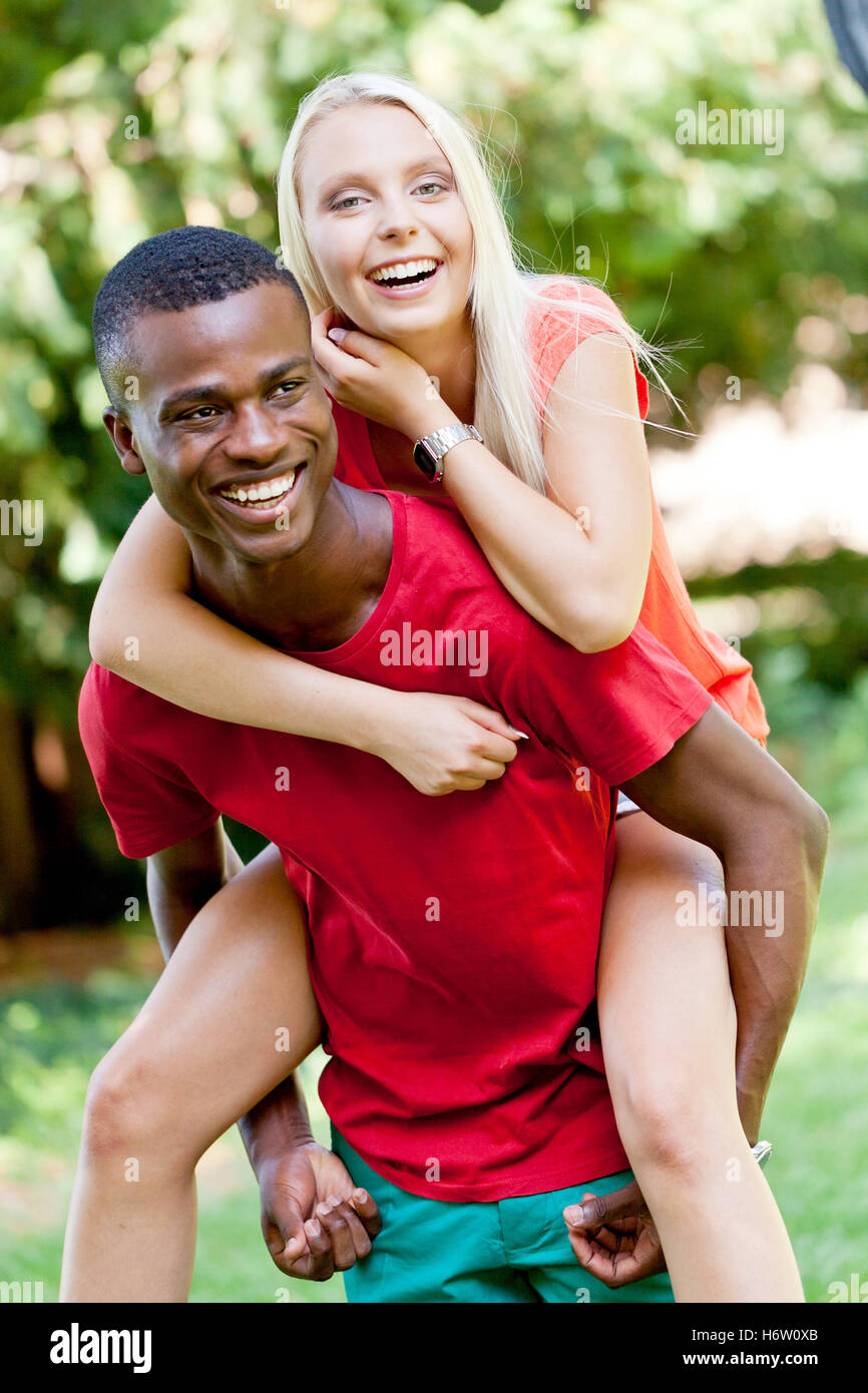 young enamored multicultural couple in a meadow Stock Photo