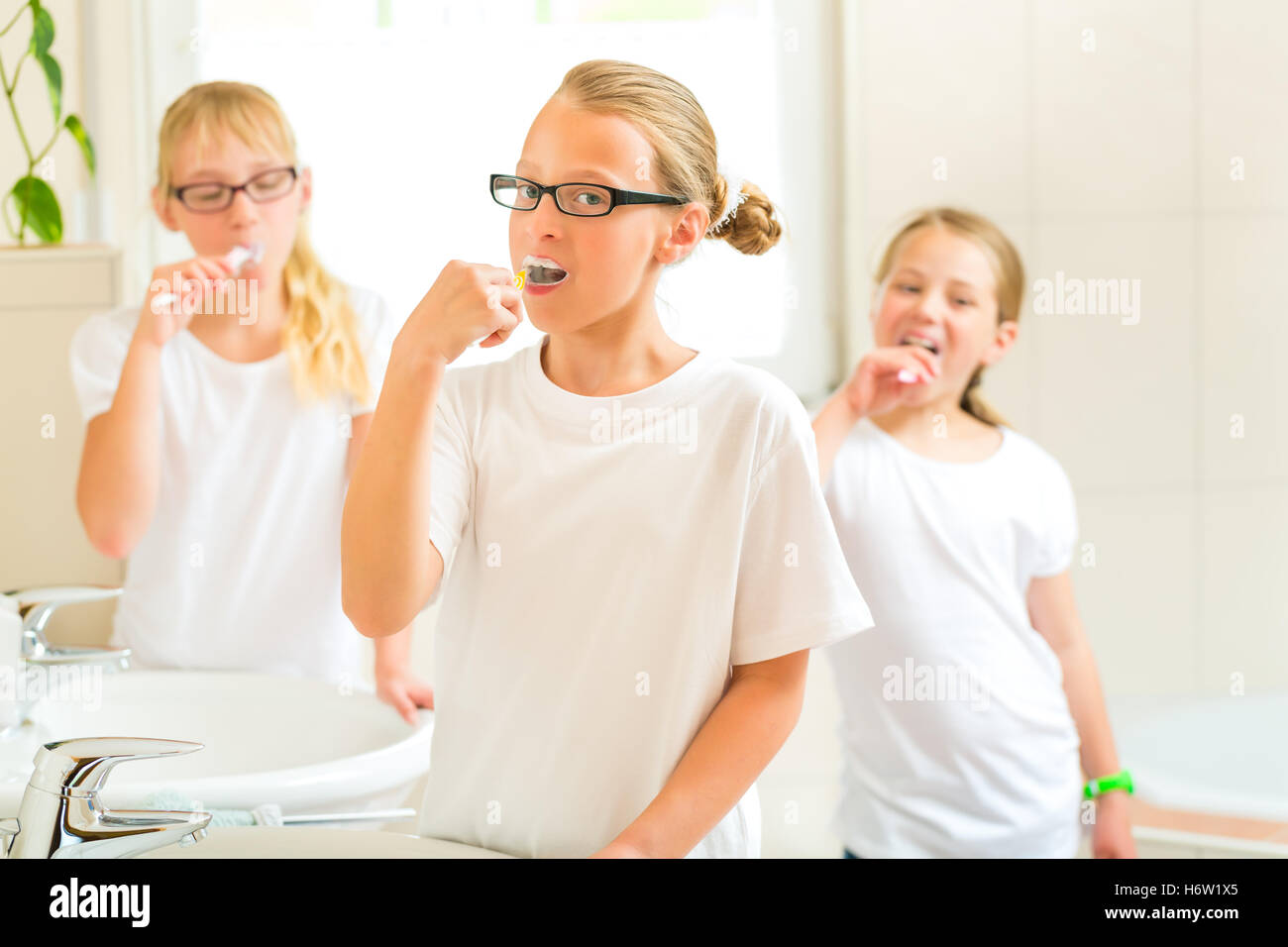 girl when brushing teeth in the bathroom Stock Photo