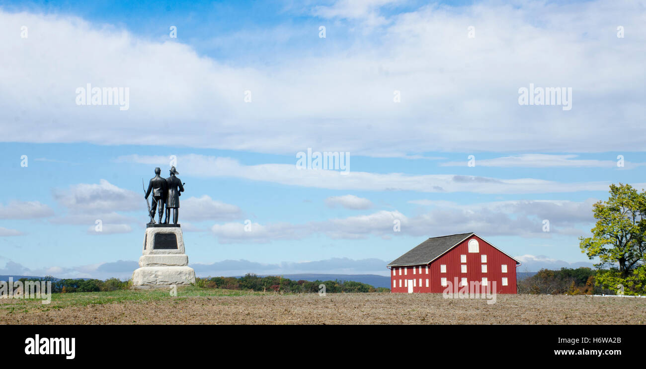 Monument to the 73rd New York Infantry in Excelsior Field in the Gettysburg Peach Orchard. Red Pennsylvania barn is at right. Stock Photo
