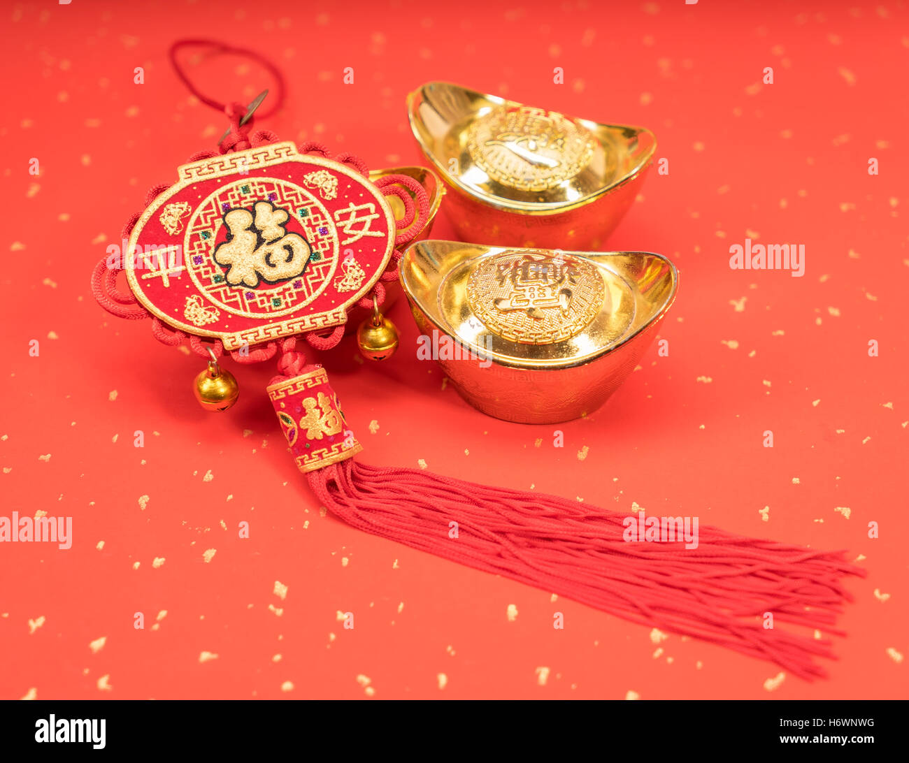 Traditional chinese knot and gold ingot mean symbols of wealth and