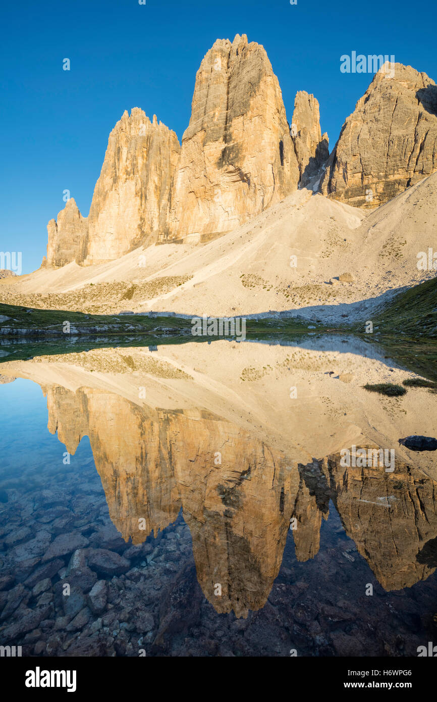 Evening reflection of Tre Cime di Lavaredo, Sexten Dolomites, South Tirol, Italy. Stock Photo