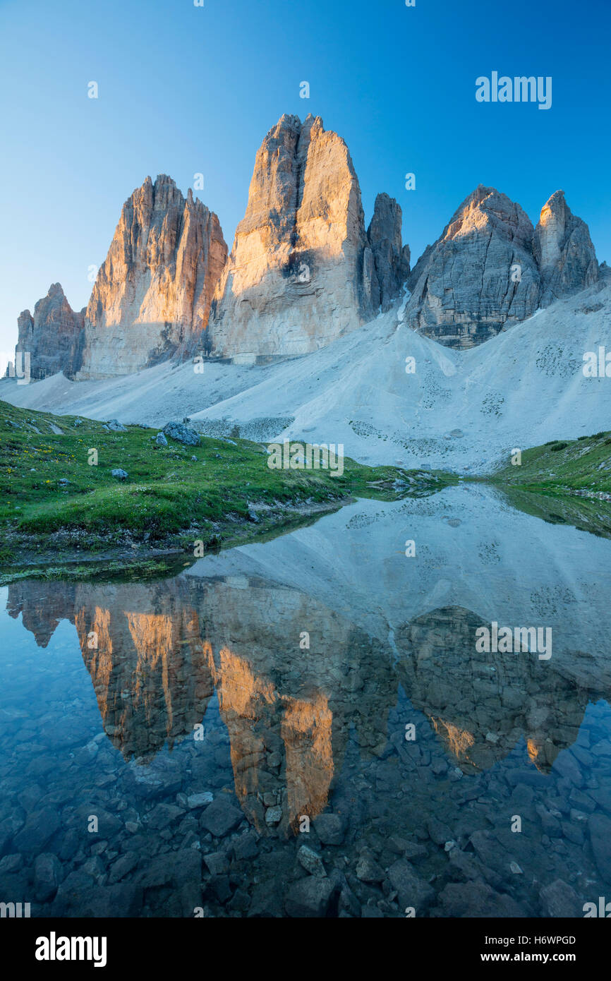 Dawn reflection of Tre Cime di Lavaredo, Sexten Dolomites, South Tyrol, Italy. Stock Photo
