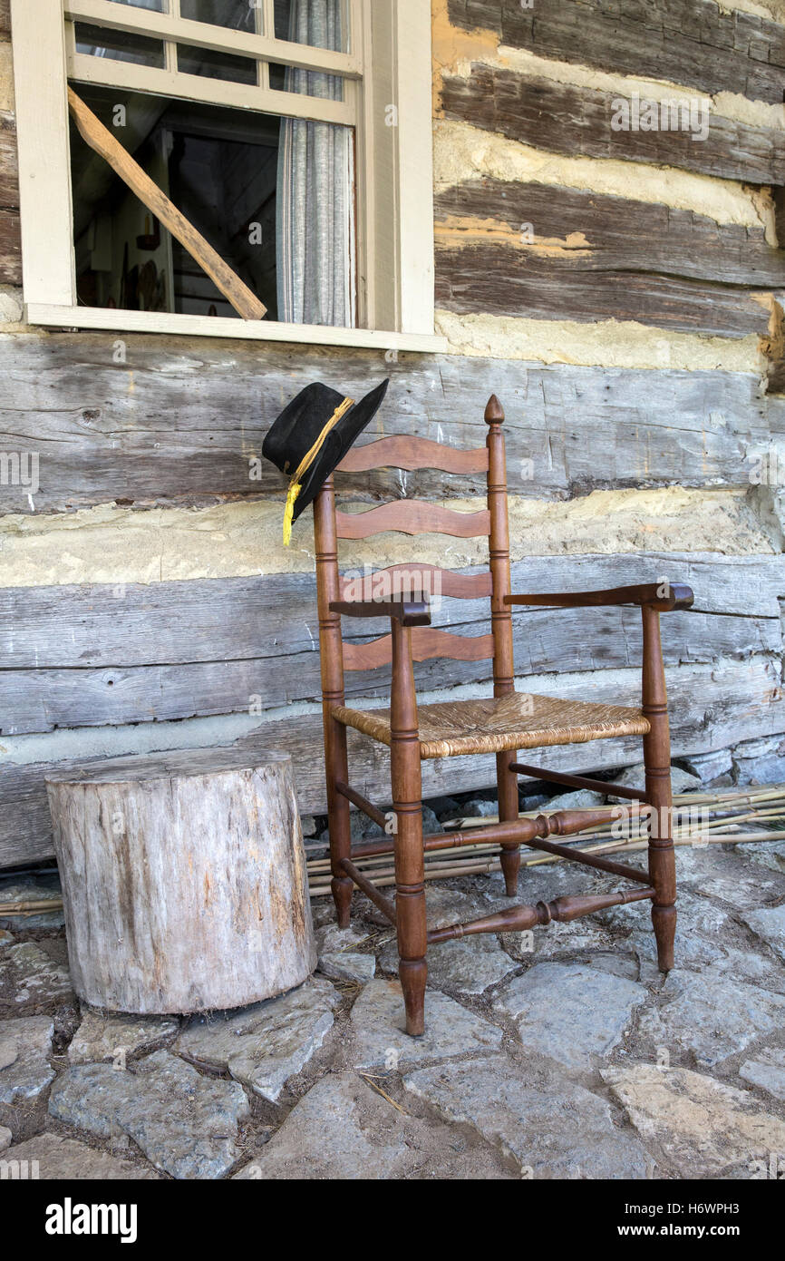 Wood chair on the porch of a cabin (Caesar Creek State Park Historical Village, Ohio) Stock Photo