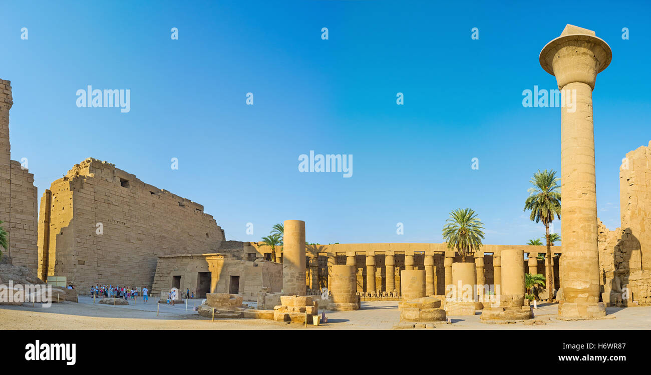 Panorama of the courtyard of the Karnak Temple with the side colonnades and ruins of the massive columns, Luxor Stock Photo
