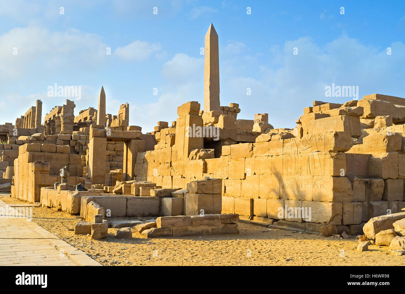 The ruins of Karnak Temple Complex with the rising granite obelisks on the background, Luxor, Egypt. Stock Photo