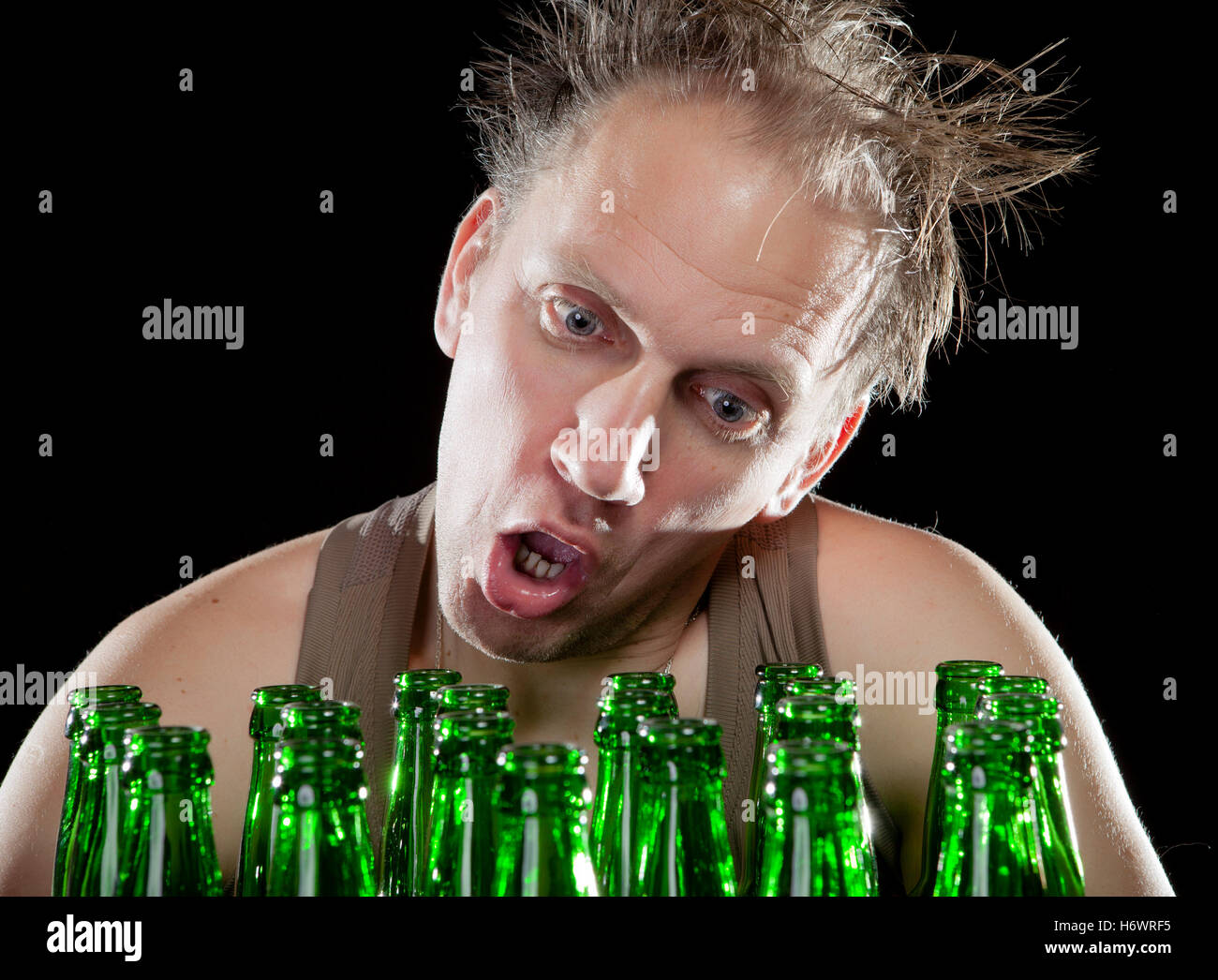 The happy tipsy man near empty beer bottles Stock Photo Alamy