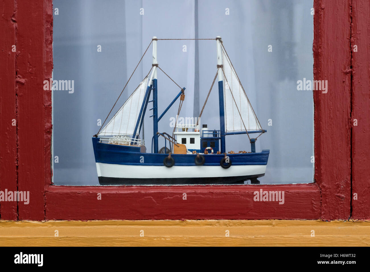 Little fishing vessel as window decoration in Fjällbacka, Sweden Stock Photo
