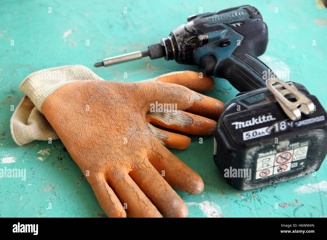 Safety gloves and drill Stock Photo