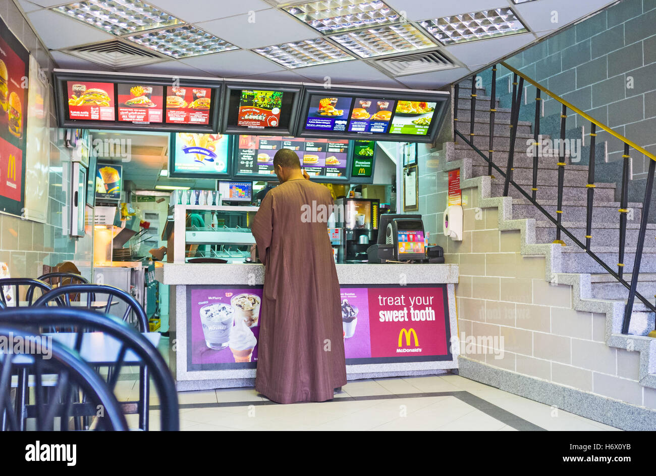 The traditionally dressed egyptian in McDonalds Stock Photo