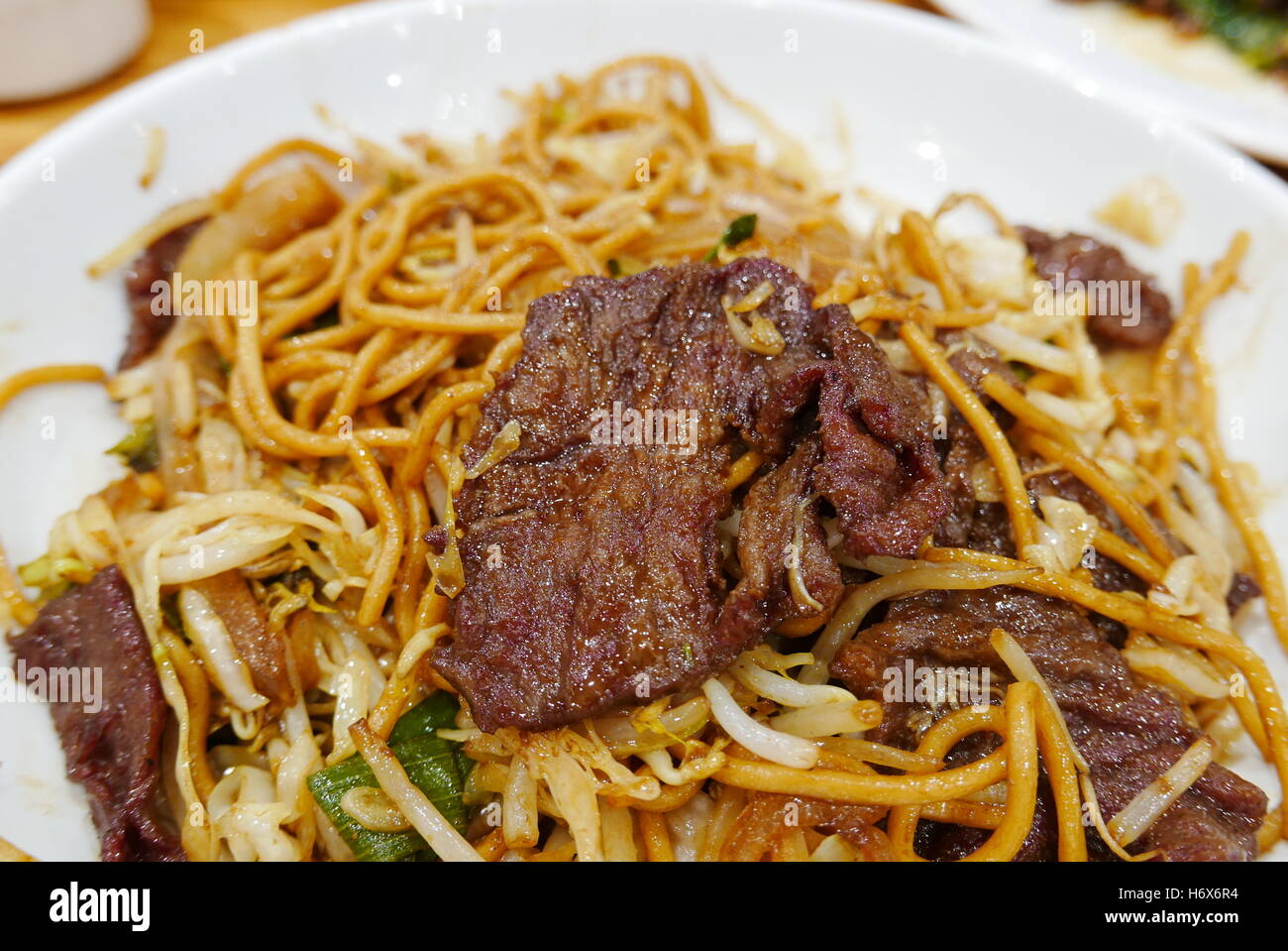 Delicious Chinese style fry noodles with beef meat Stock Photo