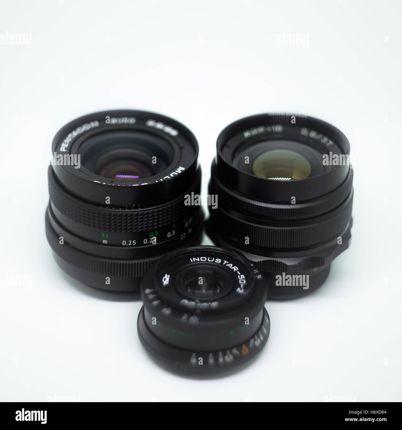 Three retro analogue camera lens on white background Stock Photo