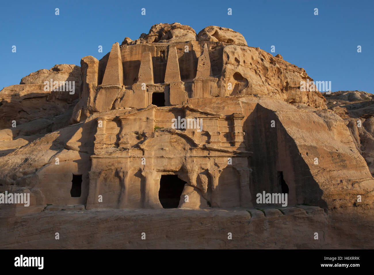 Ancient rock cut monument carved into pink sandstone cliff ( 25-75 AD ...
