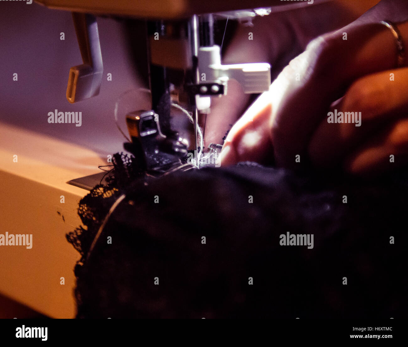 Sewing lace dress with sewing machine Stock Photo Alamy