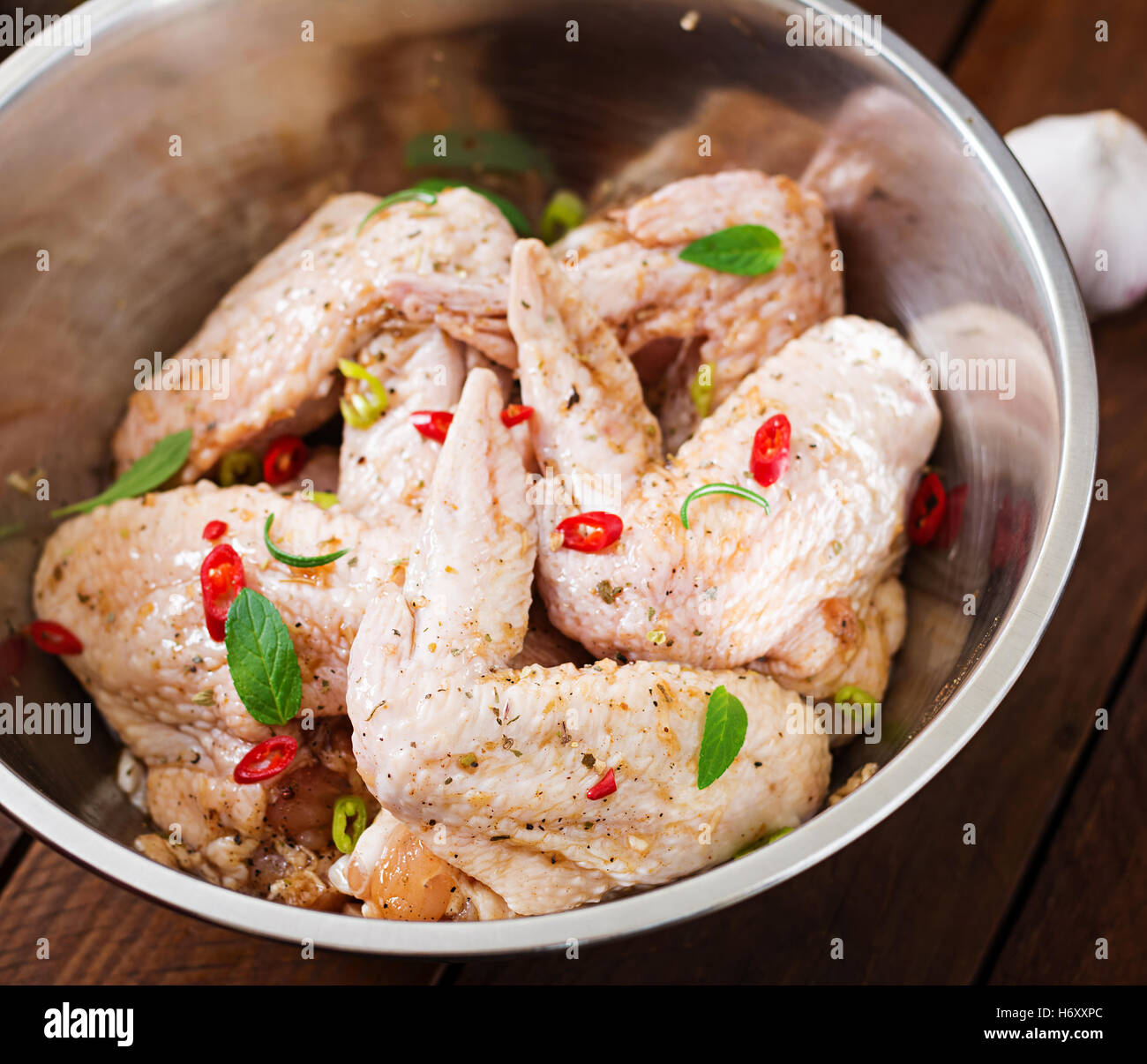 Raw marinated chicken wings prepared in Asian style with honey, garlic