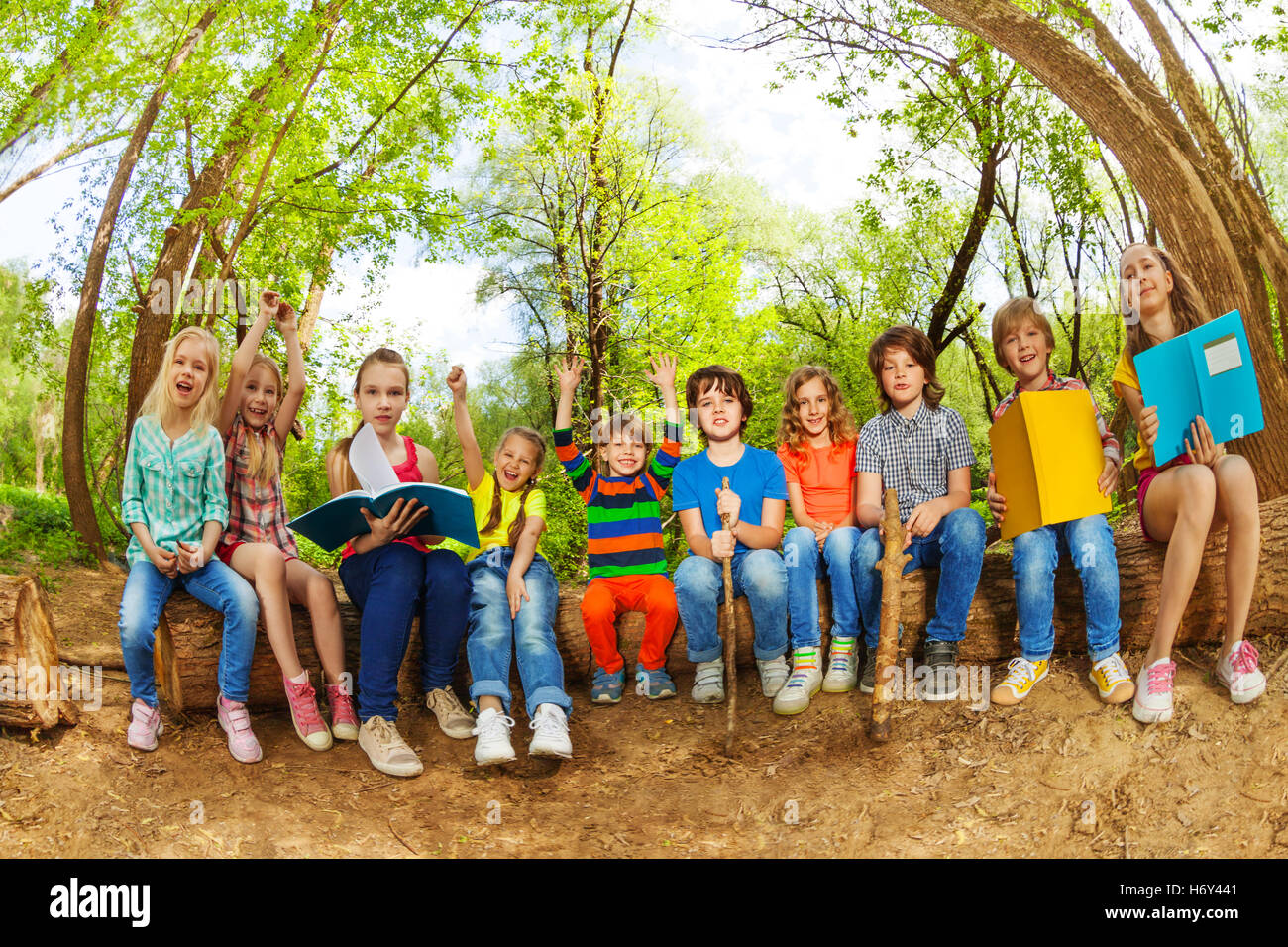 Happy Kids Reading Books Outdoor In Summer Camp Stock Photo Alamy