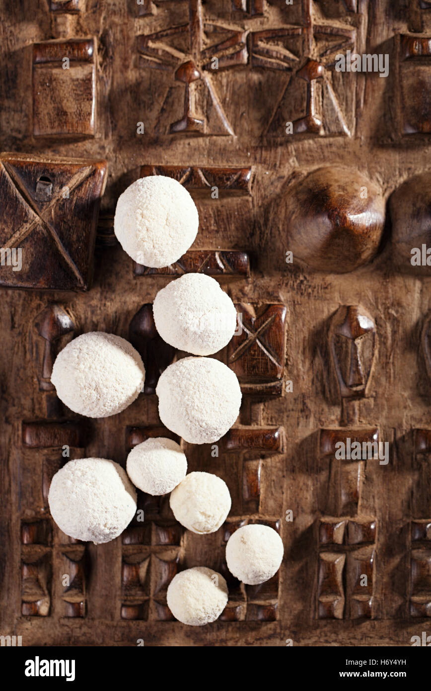 kurt kurut asian dried yogurt balls on carved wooden background Stock