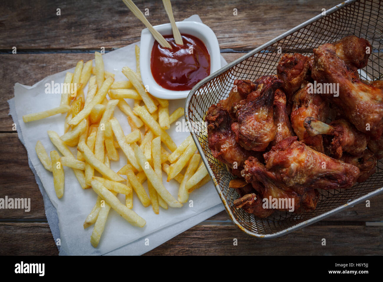 deep fried chicken wings on fryer with bbq sauce for dip Stock Photo