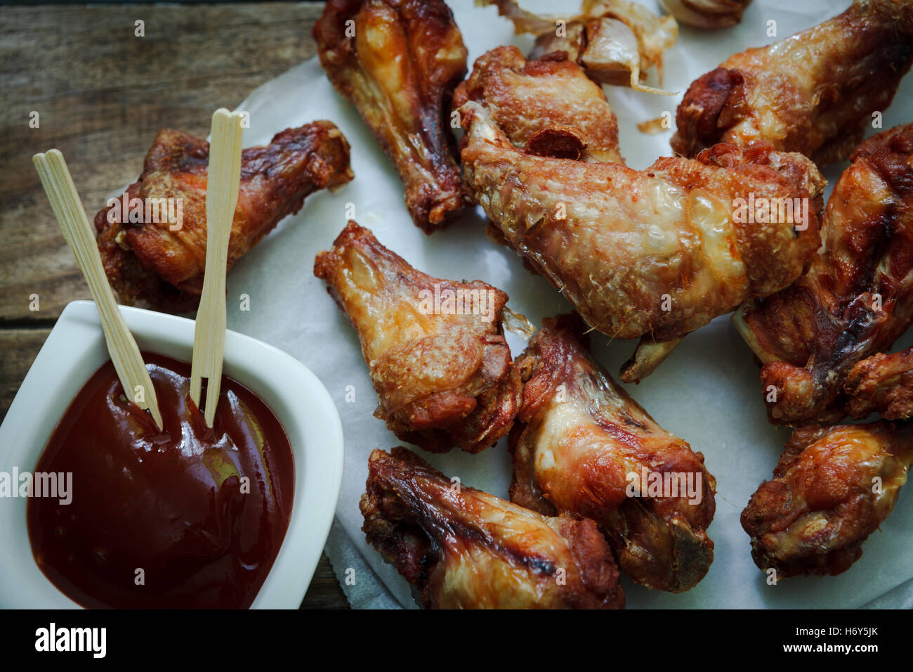 deep fried chicken wings on fryer with bbq sauce for dip Stock Photo