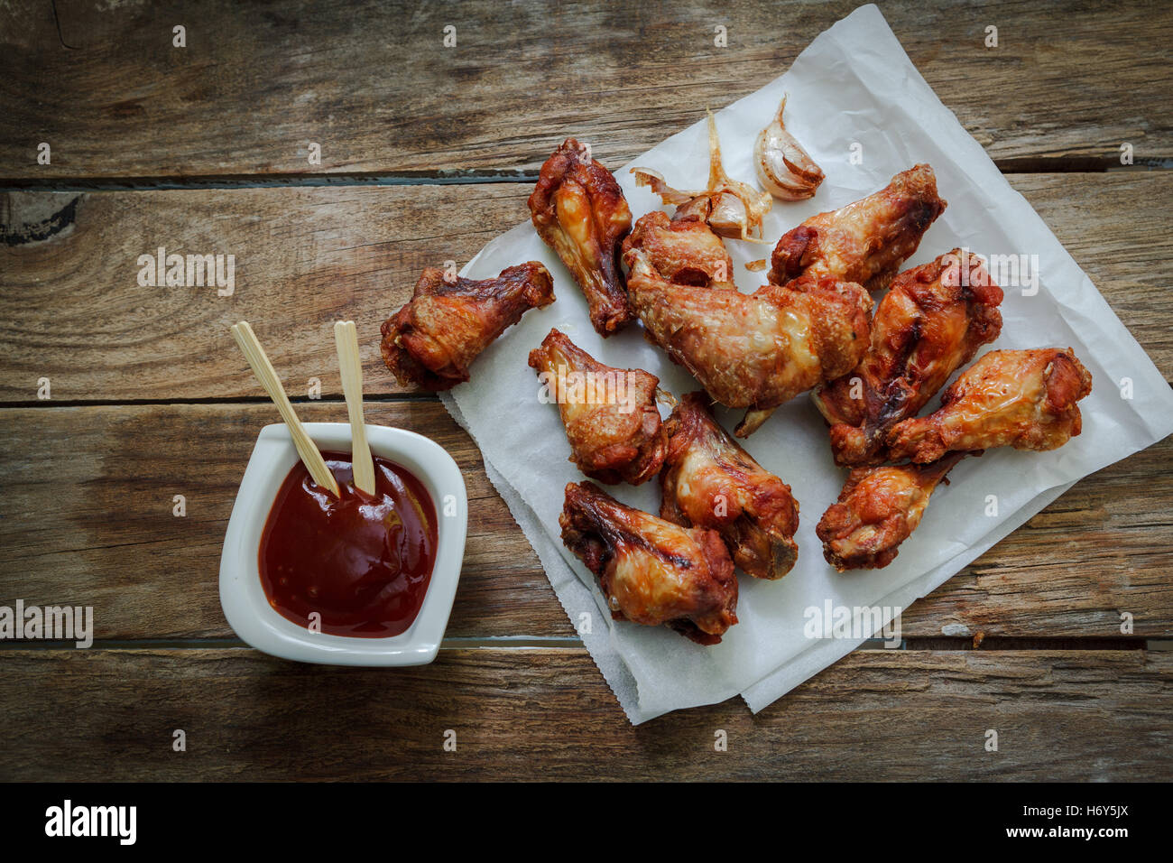 deep fried chicken wings on fryer with bbq sauce for dip Stock Photo