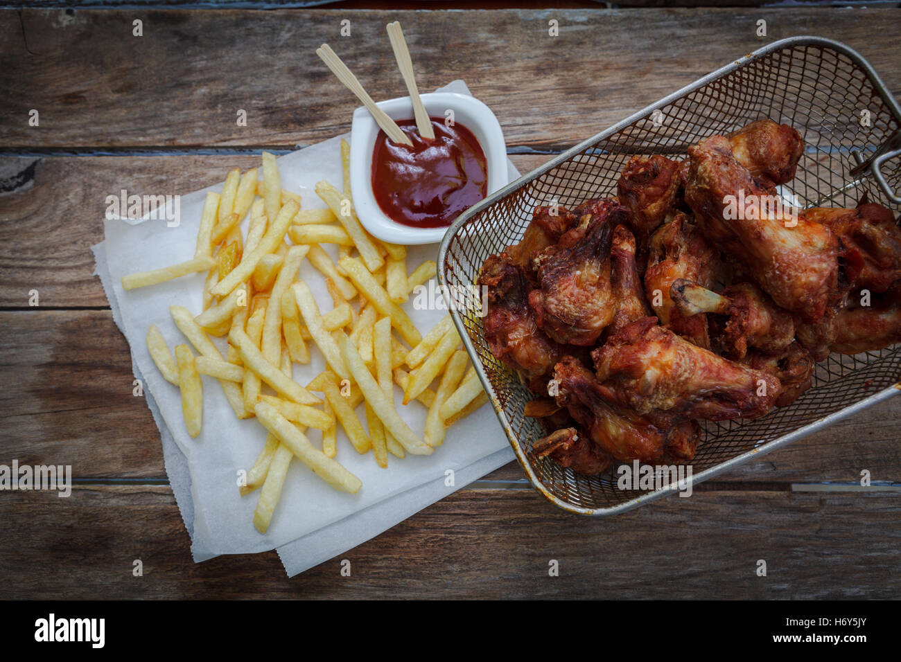 deep fried chicken wings on fryer with bbq sauce for dip Stock Photo