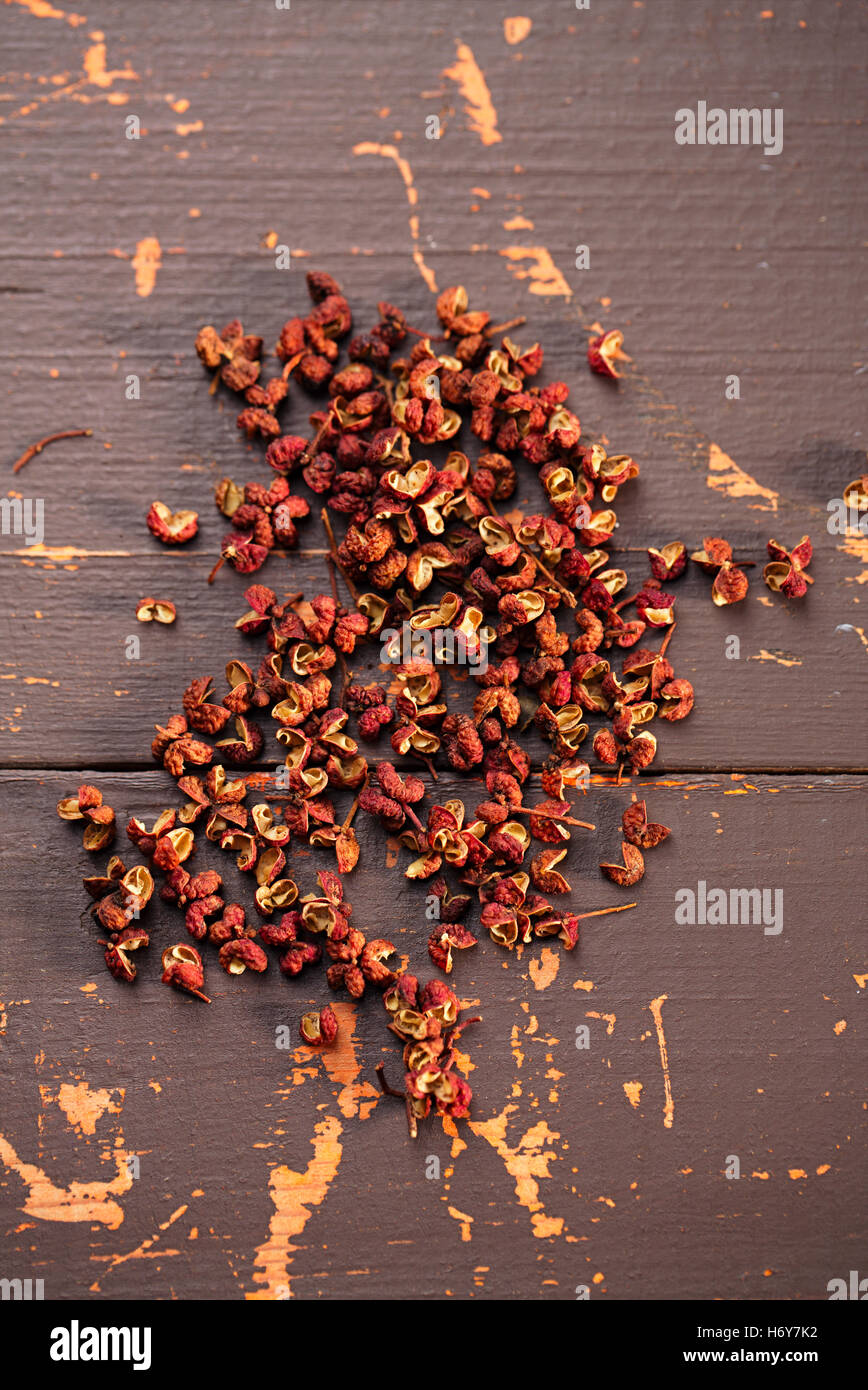 Chinese Sichuan pepper on old wooden background Stock Photo