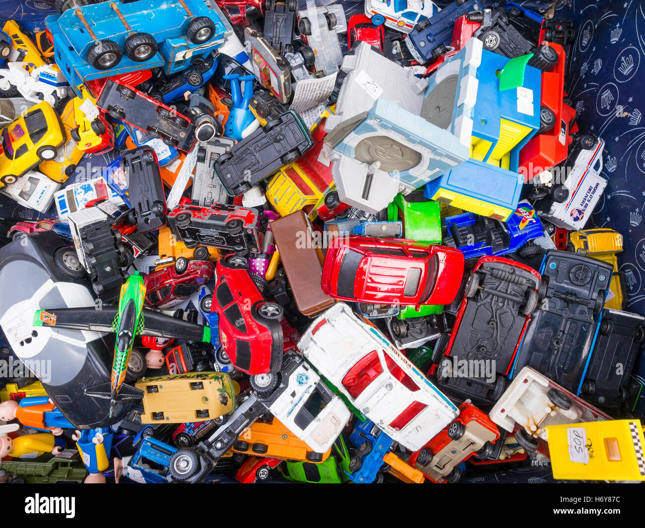 A collection of assorted vintage toy vehicles in a box in an English
