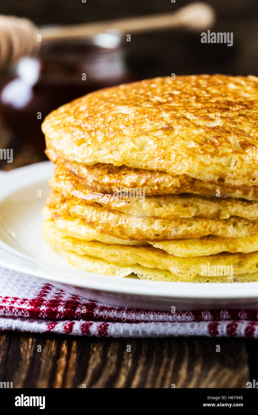 Tasty traditional russian breakfast of pancakes with honey on plate. Rustic  style. Stock Photo by ©Svetlana_Cherruty 151382336