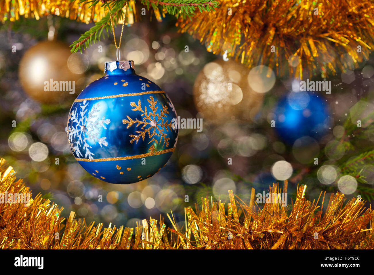 Decoration bauble on decorated Christmas tree Stock Photo