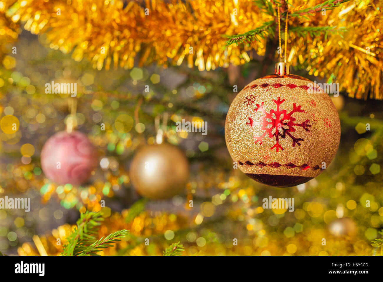 Decoration bauble on decorated Christmas tree background Stock Photo