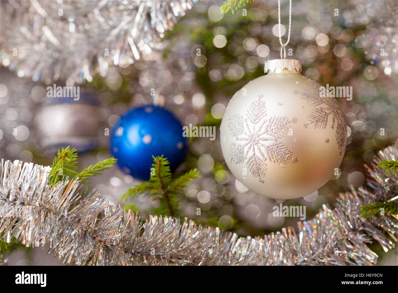 Decoration bauble on decorated Christmas tree Stock Photo