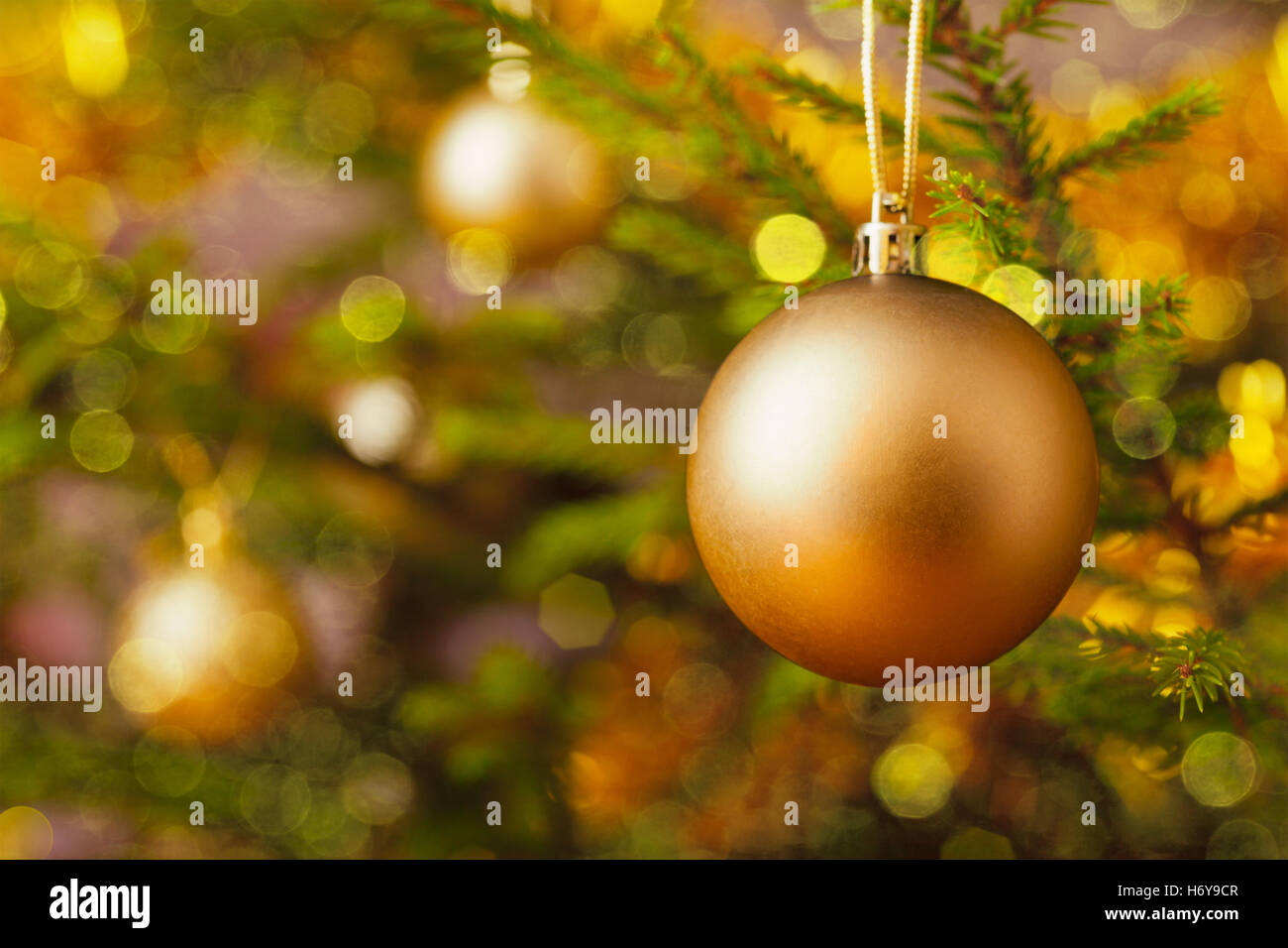 Decoration bauble on decorated Christmas tree Stock Photo